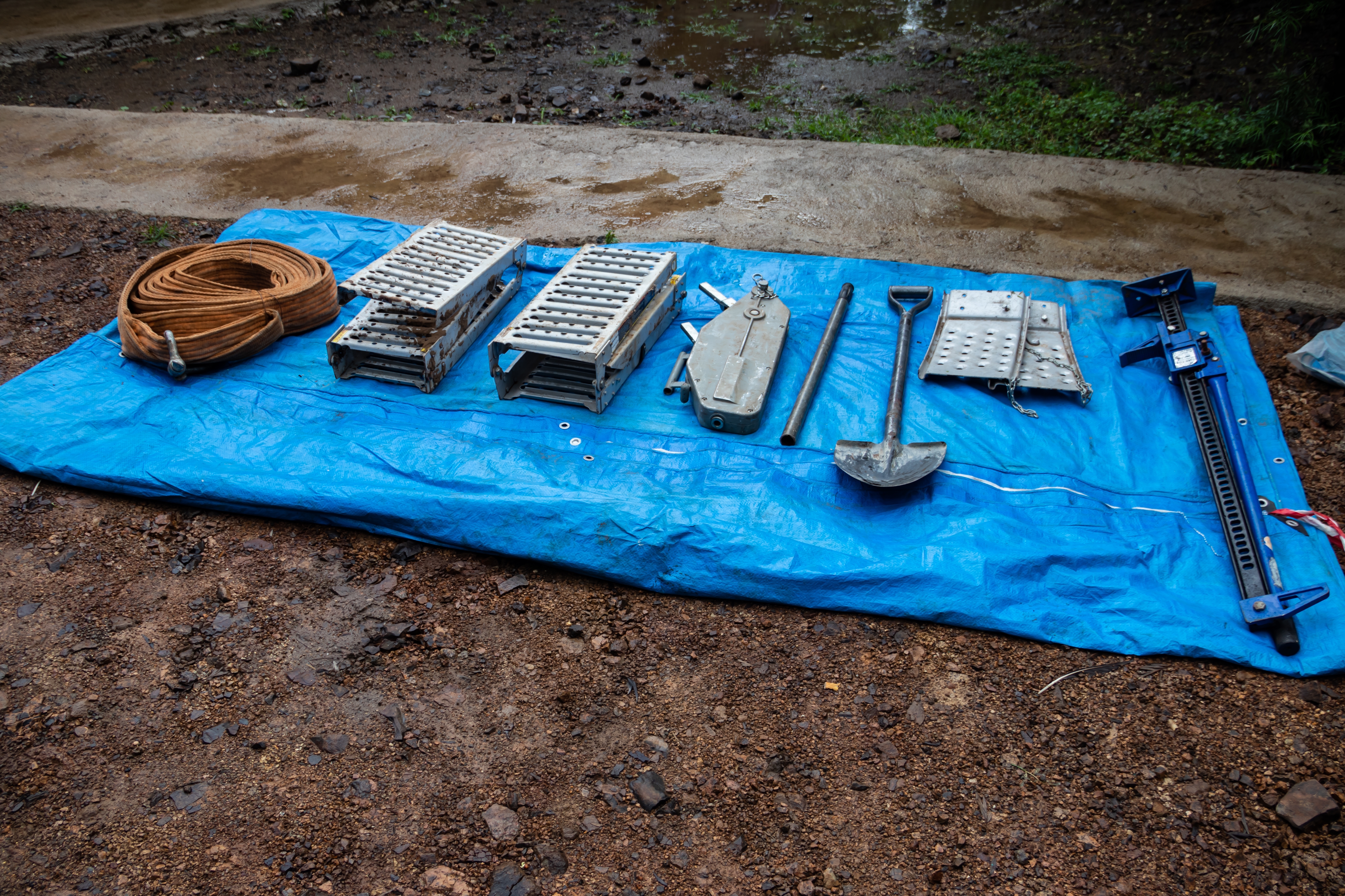 A group of recovery items on a tarp for freeing stuck vehicles